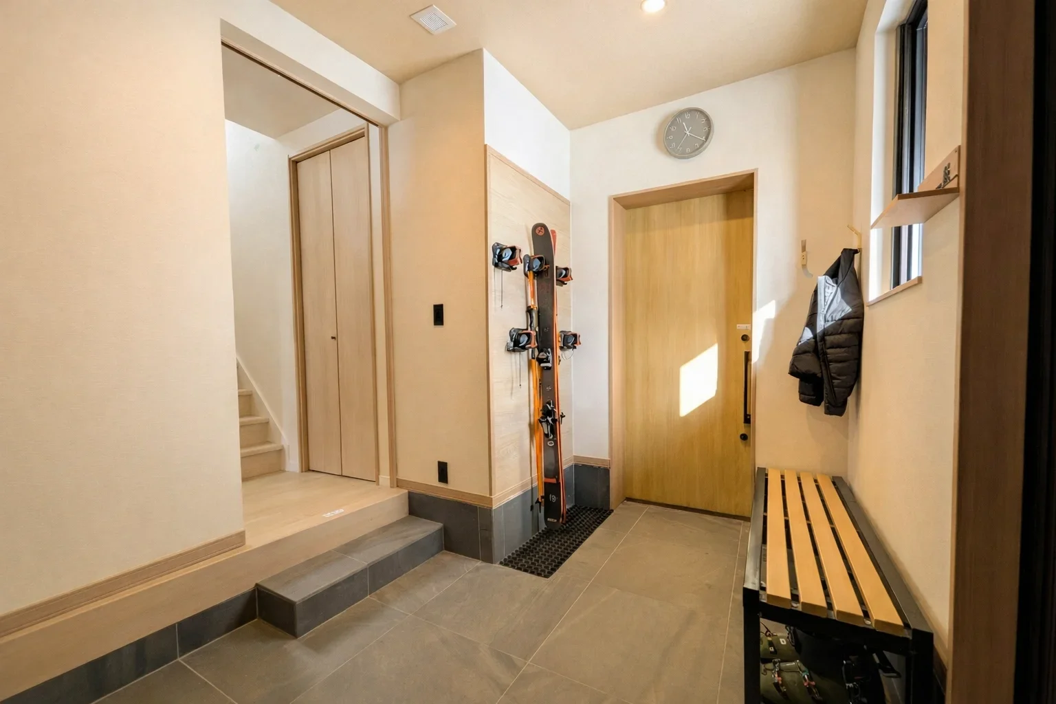 Heated genkan entrance with ski storage at Villa Matsu